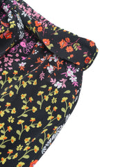 Black palazzo trousers with a vibrant floral print and a tie-waist detail.