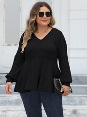 Black ribbed peplum knit top with blouson sleeves and v-neckline