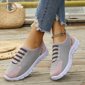 Mesh slip-on sneakers in pink and gray with black stripes and round toe.