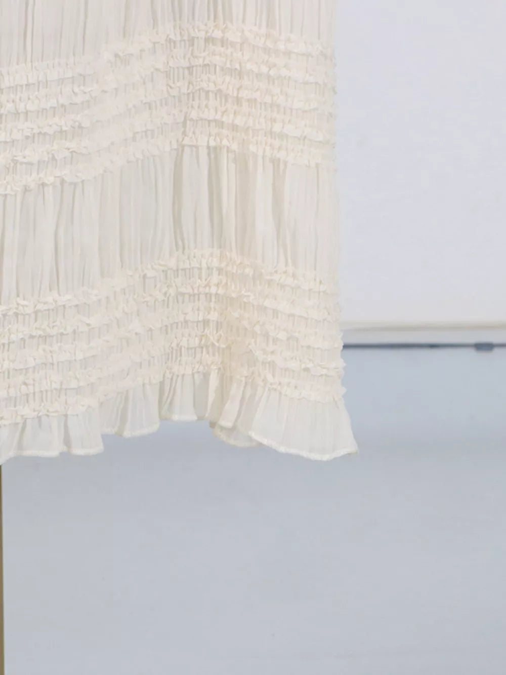 Textured cream halter neck maxi maternity swim dress with tiered ruffles.