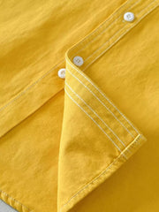 Yellow men's button-up shirt with contrast stitching and white buttons