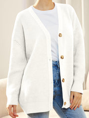 White ribbed knit cardigan with balloon sleeves and button front, styled with a t-shirt and jeans.