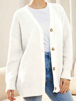 White ribbed knit cardigan with balloon sleeves and button front, styled with a t-shirt and jeans.