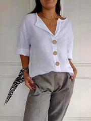 White linen button-down shirt with relaxed fit and wooden buttons.