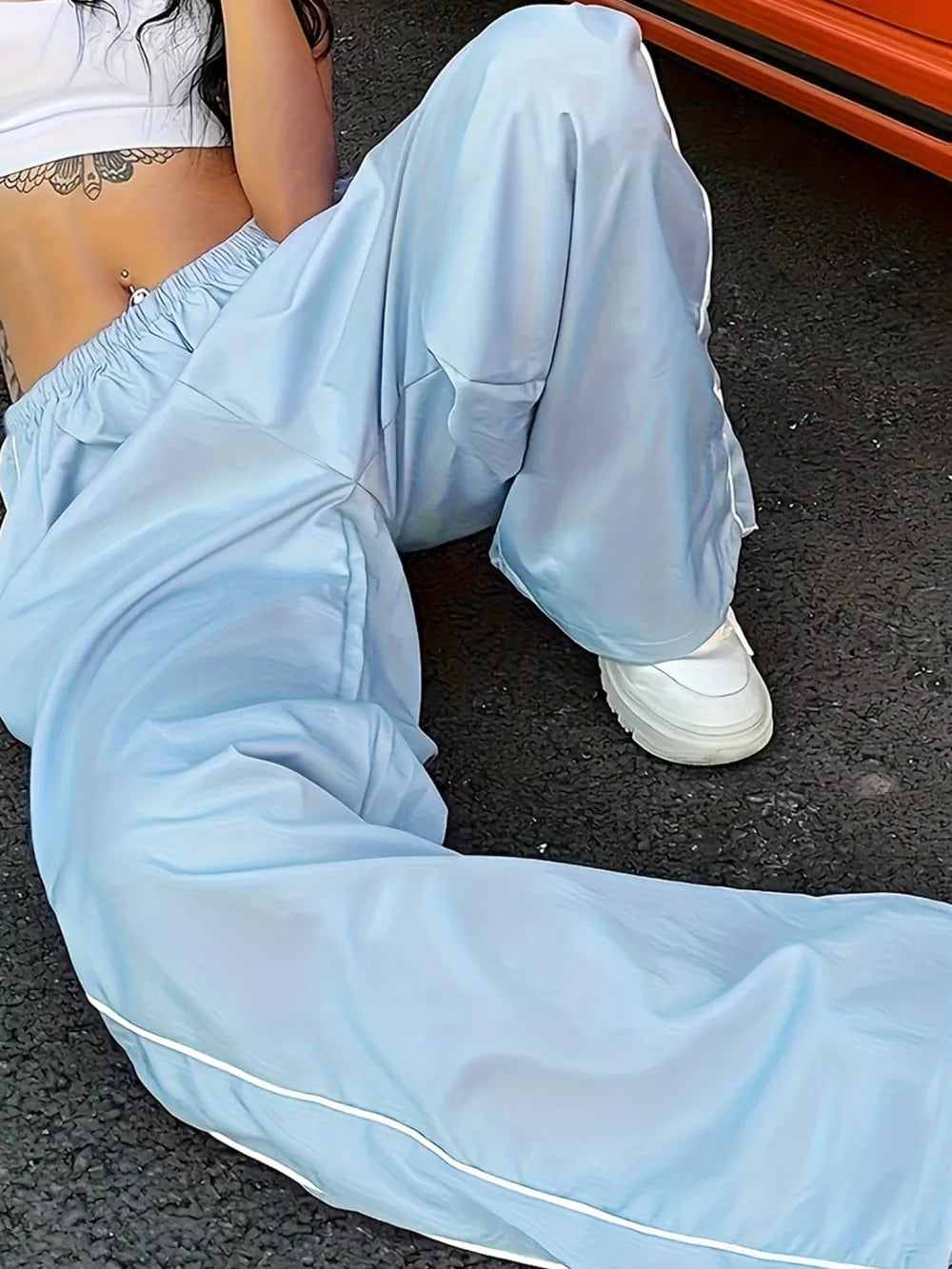 Light blue wide-leg maternity pants with gathered waistband and white piping detail.
