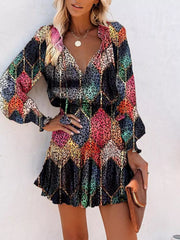 Abstract leopard print tiered mini dress with ruffles and long sleeves.