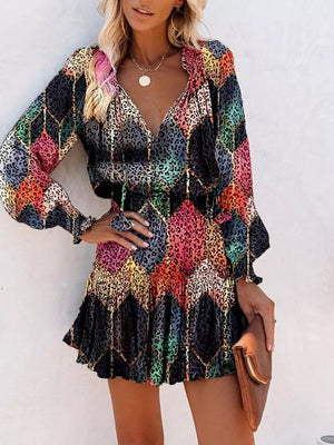 Abstract leopard print tiered mini dress with ruffles and long sleeves.