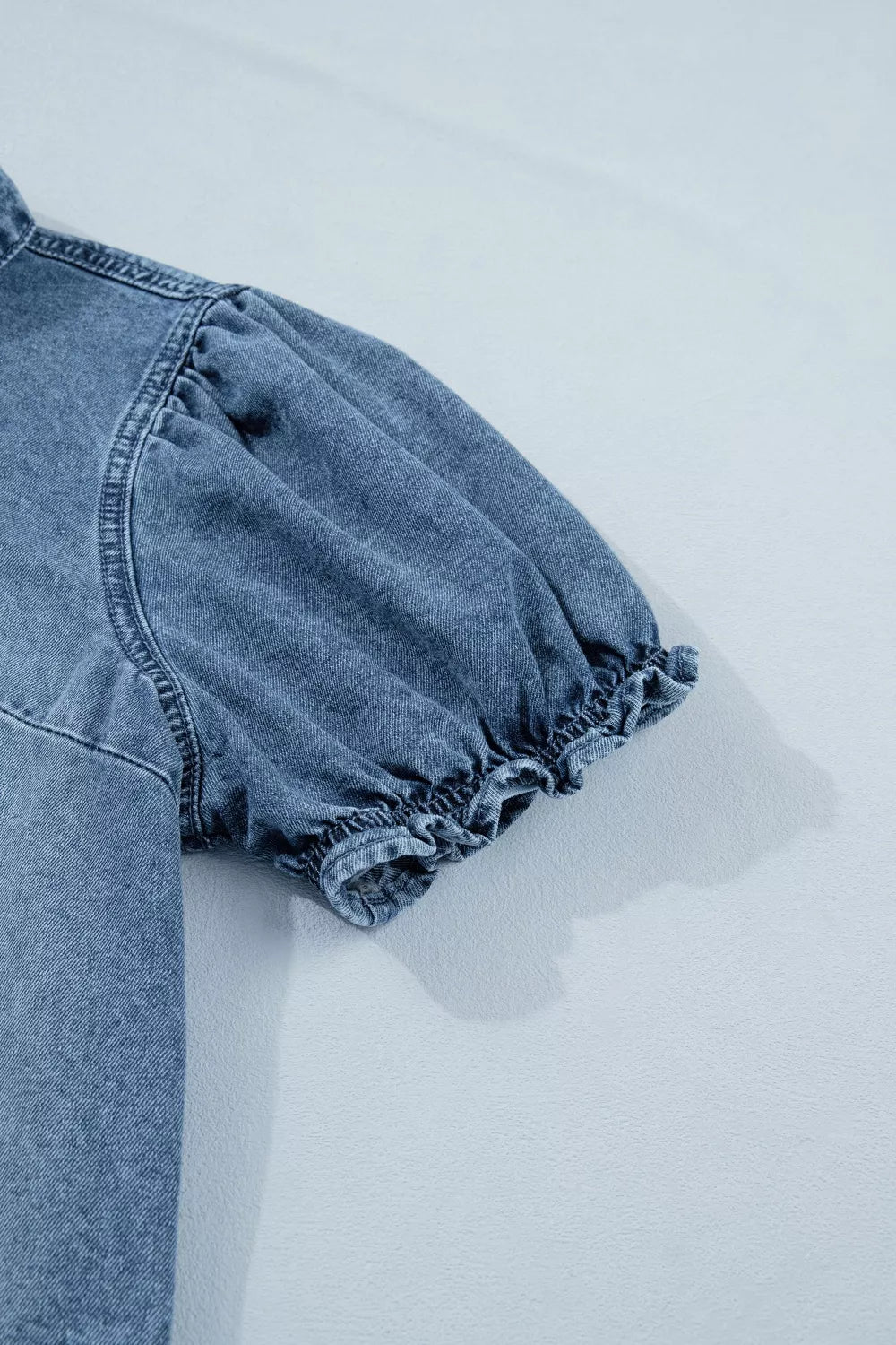 Denim shirt with puff sleeves and ruffled cuffs.