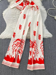 Red tropical print wide leg pants with drawstring waist and a matching belted top.