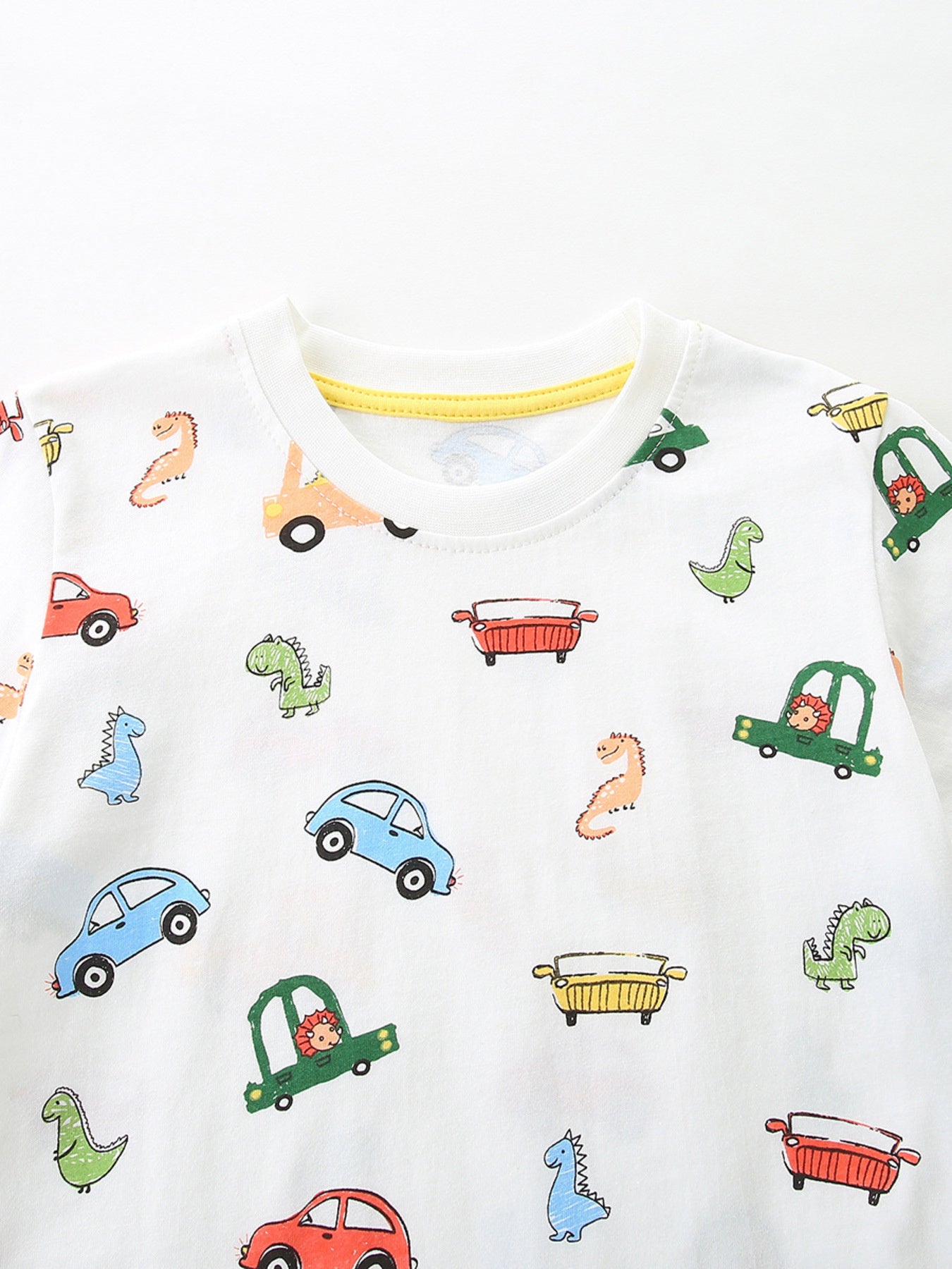 White cotton t-shirt with cartoon cars and dinosaurs print, crew neck.