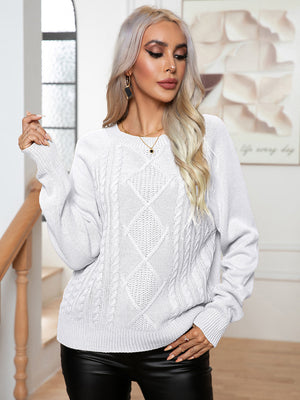 White cable knit raglan sleeve pullover sweater with diamond pattern.