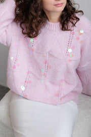 Blush pink diamond knit sweater with scattered iridescent sequins and open knit details.