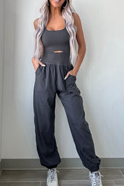 Dark gray cutout bodice gathered-leg jumpsuit with pockets and elastic cuffs.