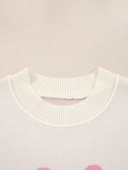 Beige acrylic blend sweater with drop shoulders and a bow print, featuring a ribbed neckline detail.