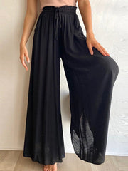 Black gathered waist palazzo pants with a drawstring and wide legs.