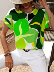 Women's abstract floral print tee in green and yellow with short sleeves.