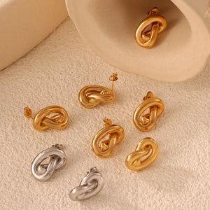 Sculptural knot stud earrings in gold and silver, artistic and chic accessories.