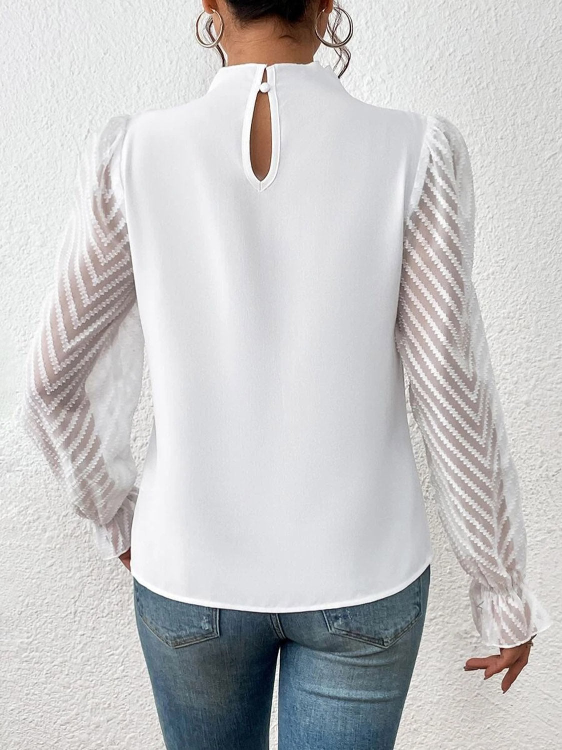White ruffle neck blouse with sheer chevron sleeves and keyhole back detail