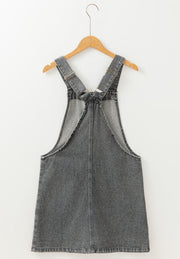 Gray faded denim pinafore dress with adjustable straps and a straight cut.