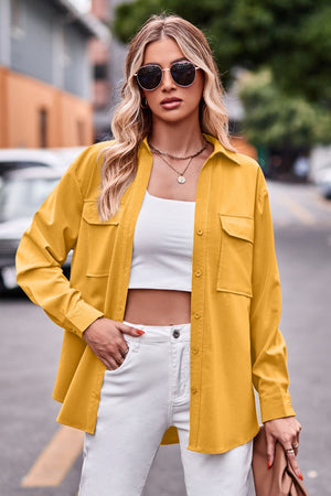 Oversized utility shirt in mustard yellow with chest pockets, button front, and long sleeves.