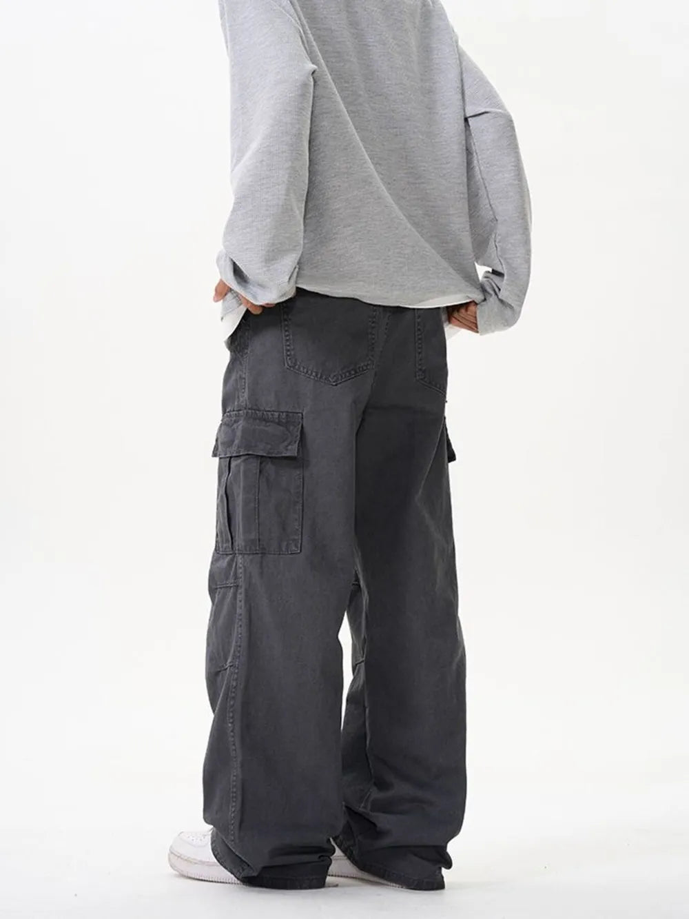 Grey cargo pants with versatile pockets and a relaxed fit.
