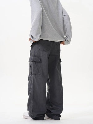 Grey cargo pants with versatile pockets and a relaxed fit.