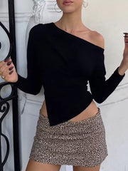 Black draped asymmetrical off-shoulder t-shirt with a long sleeve and a pointed hem.