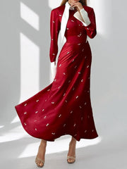 Burgundy midi dress with contrast collar, long sleeves, defined waist, and subtle white pattern.
