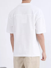 White cotton t-shirt with boxy fit and subtle shoulder seam detail.