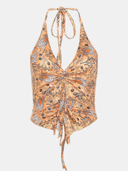 Tangerine paisley print ruched halter top with tie neck and drawstring hem.