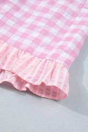 Charming gingham ruffle hemmed shorts in blush pink with striped ruffle detail.
