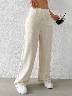 Cream wide-leg pants with button closure and front patch pockets.