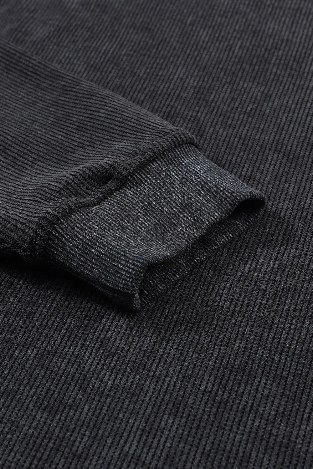 Dark Gray ribbed sweatshirt sleeve detail with textured knit and cuffed hem.