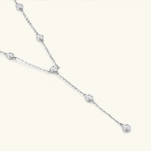 Silver lariat necklace with bezel-set moissanite diamonds on a delicate chain