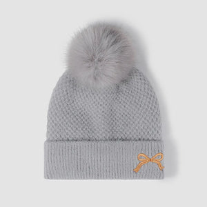 Gray knit beanie with pom-pom and embroidered bow detail