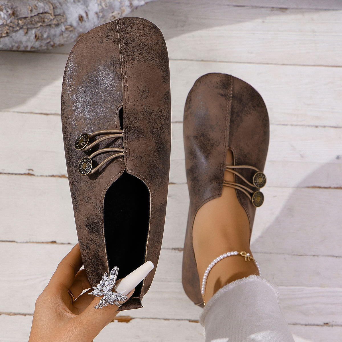 Chic dark brown round-toe casual flats with decorative buttons and elastic detail.