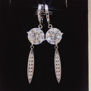 Silver moissanite orb & pavé dangle earrings with lever backs.