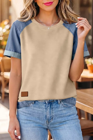 Color block t-shirt with beige body and blue denim sleeves, round neck, short sleeves, and faux leather patch.
