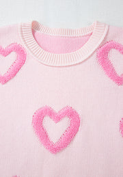 Pink knit sweater with fuzzy heart appliques and balloon sleeves.