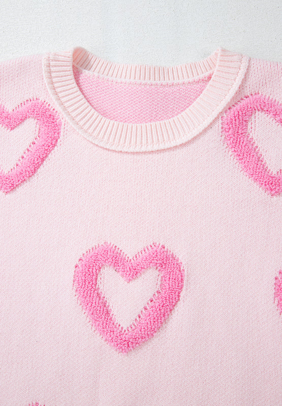 Pink knit sweater with fuzzy heart appliques and balloon sleeves.