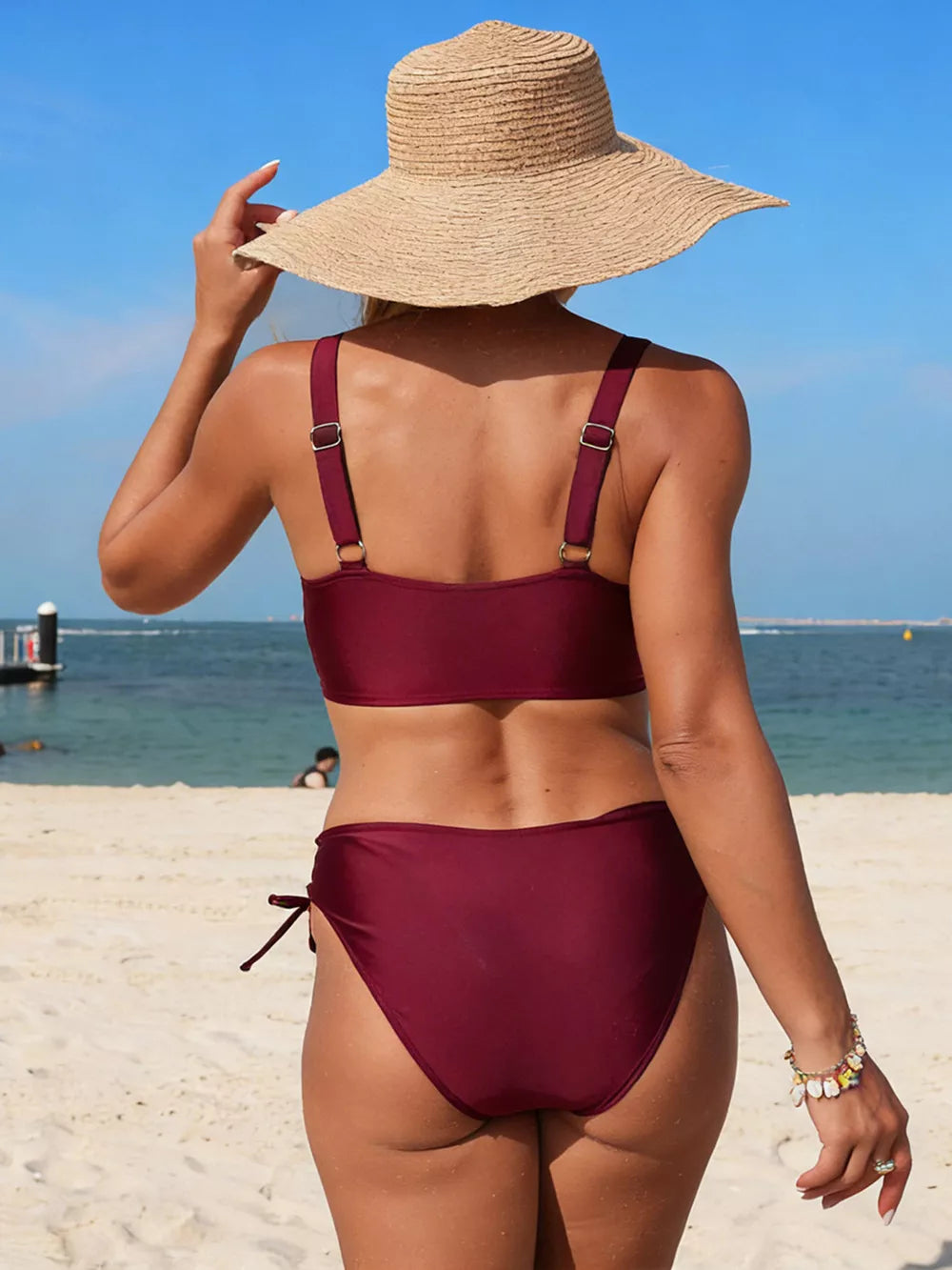 Burgundy palm tree cutout bikini with adjustable straps and tie-side bottoms.