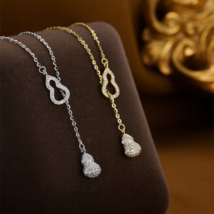 Silver and gold zircon pendant necklaces with double gourd charm.