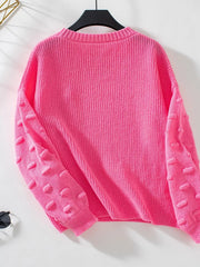 Hot pink knit sweater with textured bobble sleeves and crew neck.