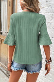 Sage green ribbed V-neck blouse with pleated bell sleeves