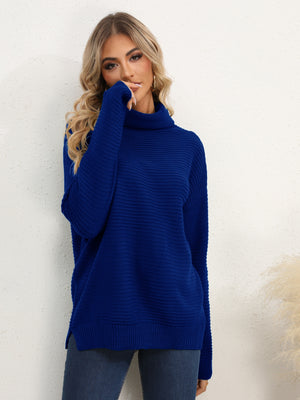 Textured knit oversized turtleneck pullover in dark blue with ribbed detail and side slits.