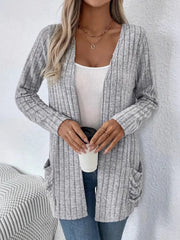 Light gray ribbed knit cardigan with drape front and pockets, worn open over a white tank top.