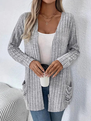 Light gray ribbed knit cardigan with drape front and pockets, worn open over a white tank top.