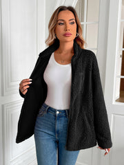 Black teddy fleece jacket with patch pocket and zip-up front.