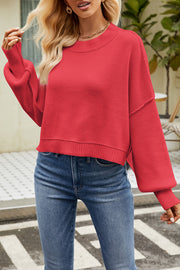 Red boxy ribbed knit sweater with crewneck and dropped shoulders.