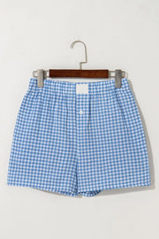 Light blue gingham boxer shorts with elastic waist and button fly.